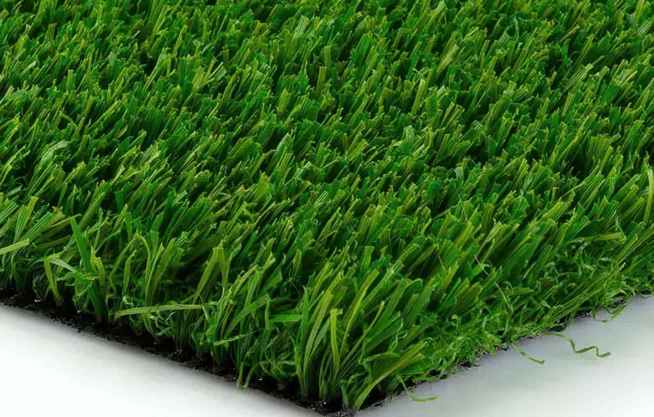 Close-up of artificial grass blades in vibrant green, showing dense texture and varying blade shapes on black backing.