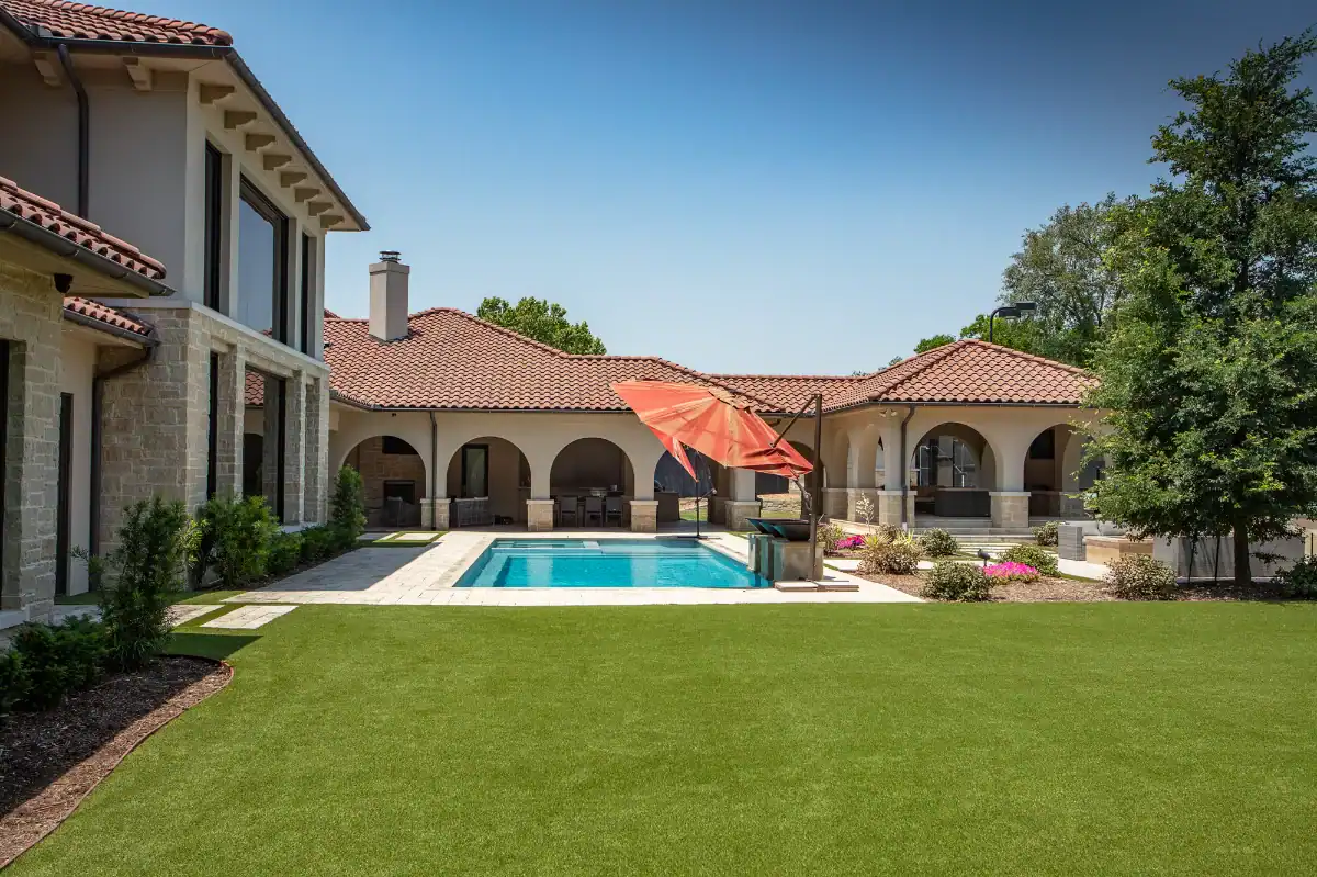Artificial Grass Backyard in Prosper behind a luxurious mansion with a pool