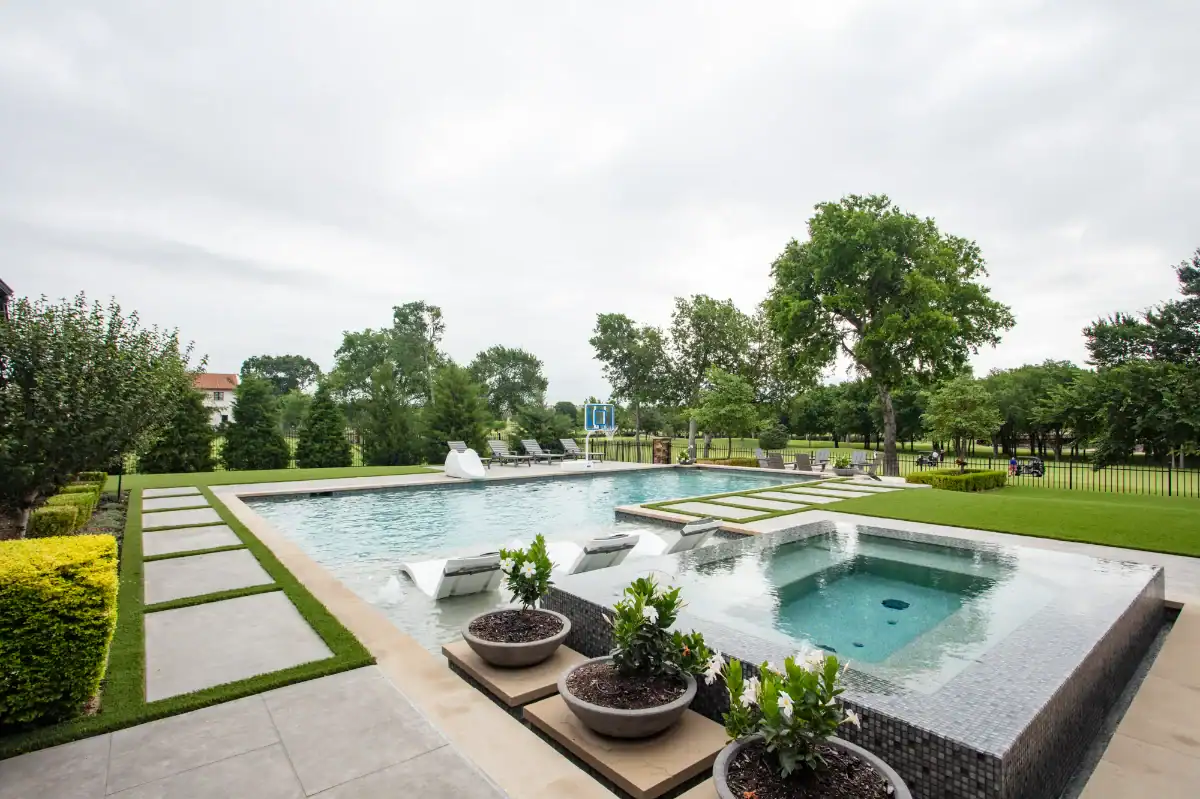 Artificial Pet Turf in Addison around a pool and hot tub with pavers