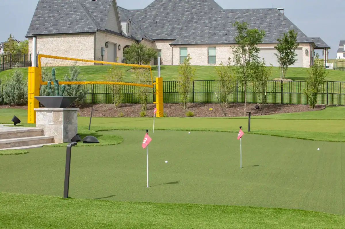 Artificial Putting Green in Westlake with outdoor lighting and an artificial turf volleyball court