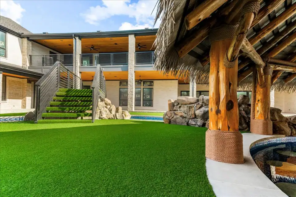Synthetic Turf Yard in Prosper around a lazy river with a swim up bar