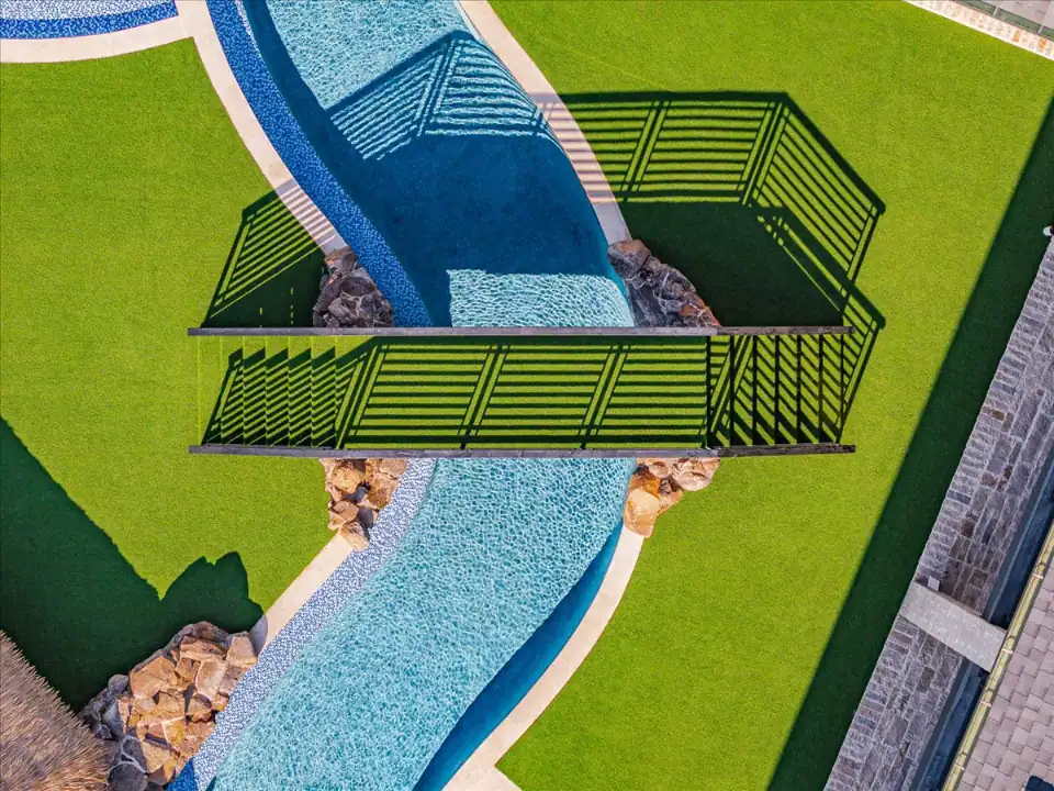 Artificial Gras Lawn in Westlake with a bridge across a lazy river