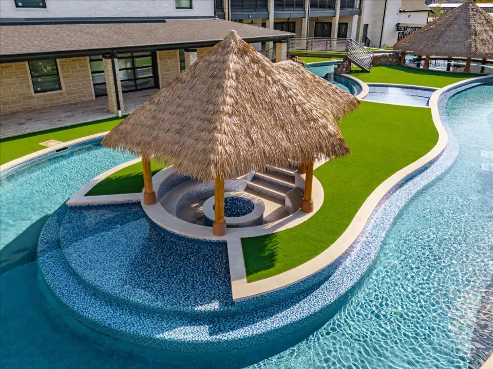 Artificial Grass Lawn in Melissa Artificial Grass Lawn in Melissa with a lazy river and fire pit in a backyard
