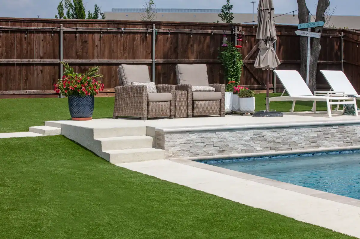 Artificial Grass Lawn in Flower Mound around a pool with seating area