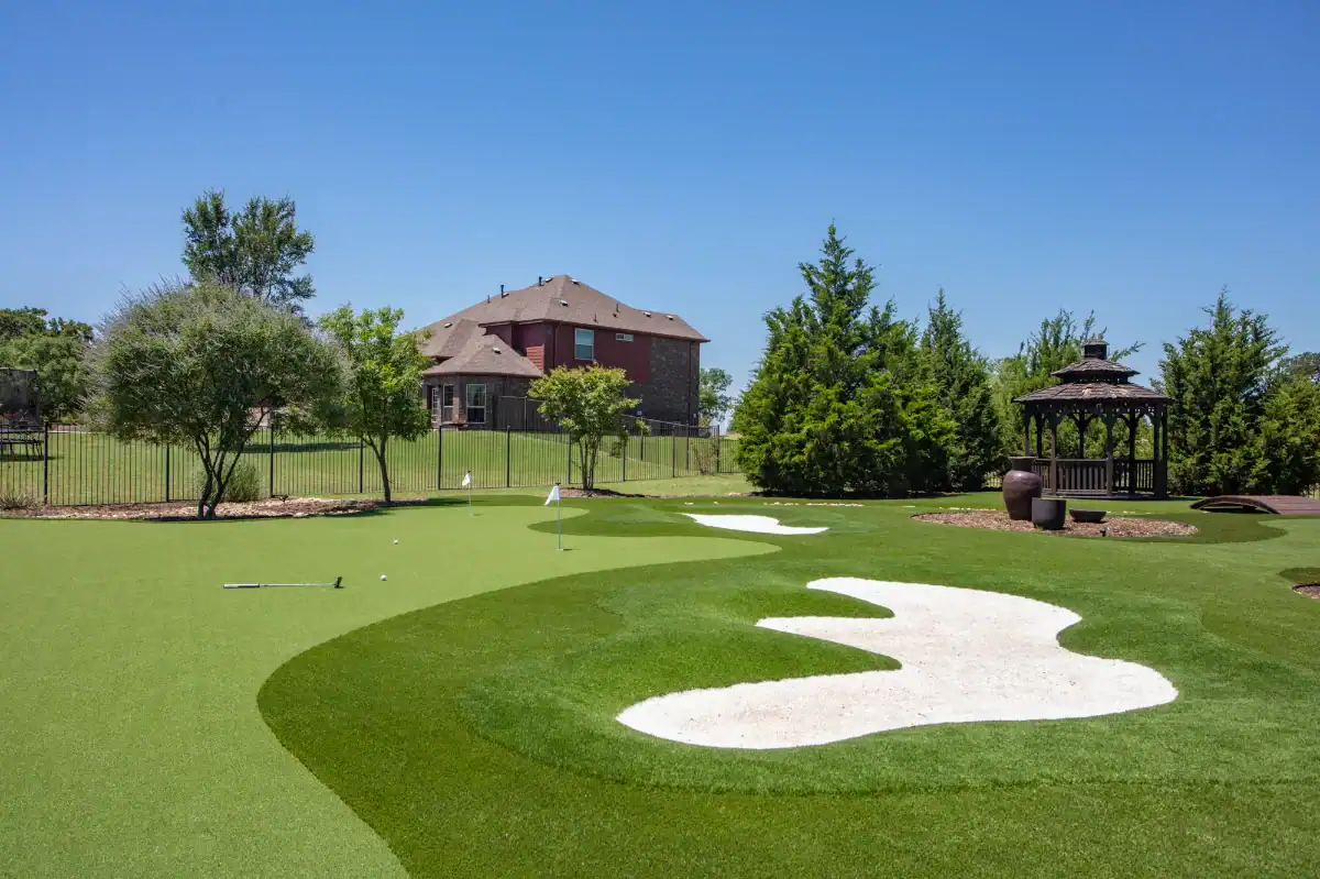 Backyard putting green with bunkers and a double fringe in a large residential backyard