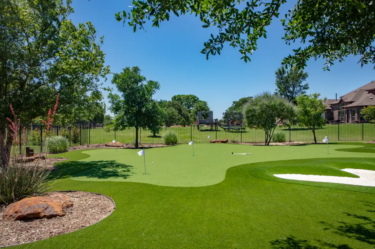 Backyard Putting Green in Fort Worth with bunkers and flower beds