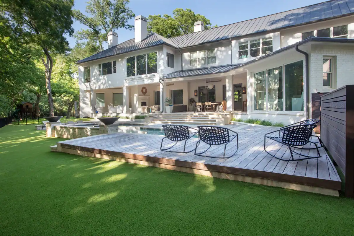 Artificial Pet Turf in Westlake around a large pool with a wood deck